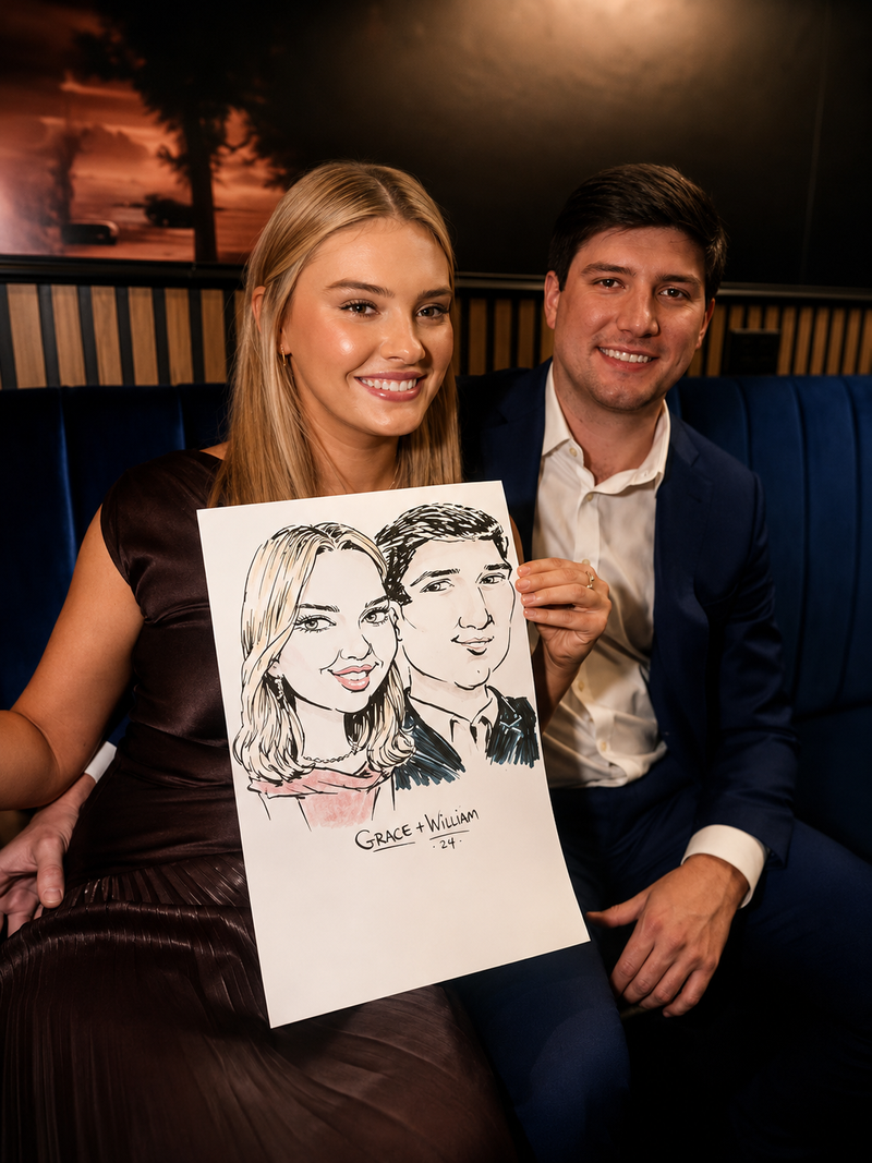 Couple holding a duo color caricature at an evening community gathering